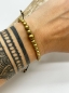 Mobile Preview: Armband "Judith" mit Messingperlen auf schwarzbraun gewachster Kordel.