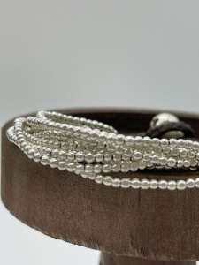 Wunderschönes Silberarmband mit zehn Strängen mit versilberten Perlen.